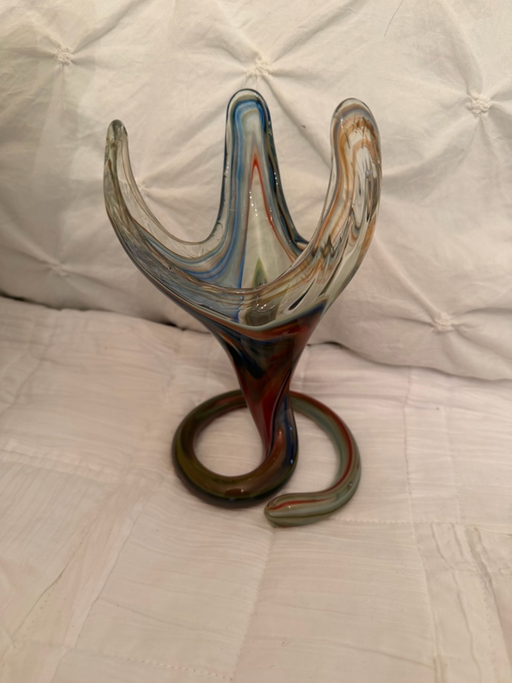 Sooner art glass vase featuring a coiled base and a stretched serpentine form